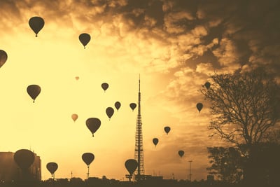 Hot air balloons in the sky against a sunset