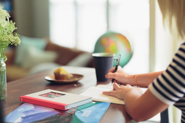 woman writing in her notebook